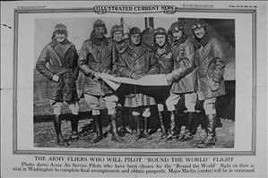 Seven white men in long coats, pilot hats, goggles, and tall boots, all smiling and grouped around a long piece of paper